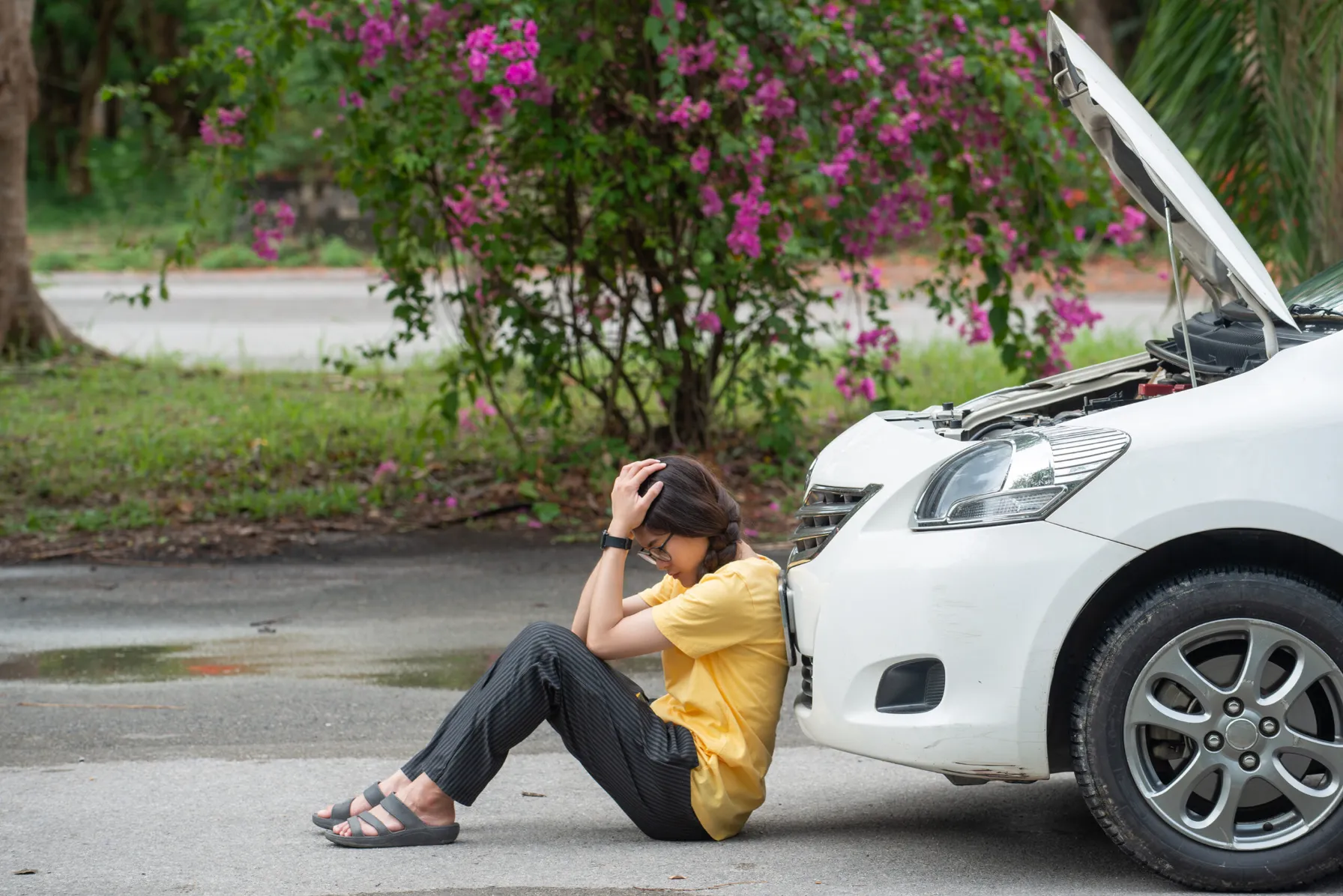 Stressed girl after car accident needing to call an auto accident attorney.