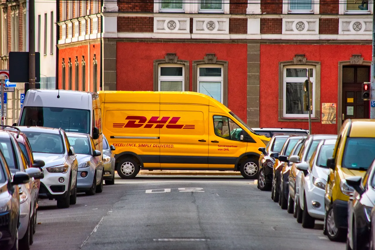 DHL truck driving down the street.