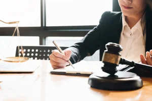 An attorney working at her desk with a gavel in front of her.