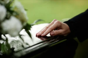 Woman placed her hand on casket. 
