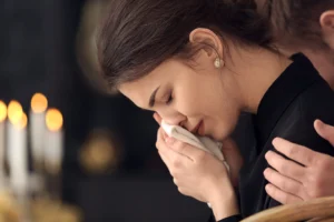 A woman crying at a funeral service.