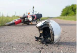 A motorcycle on the ground with a helmet.