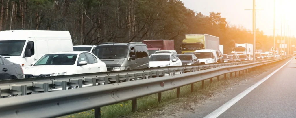 Heavy traffic on a divided highway surrounded by trees, illustrating hazardous road conditions on some of Missouri’s most dangerous roads.